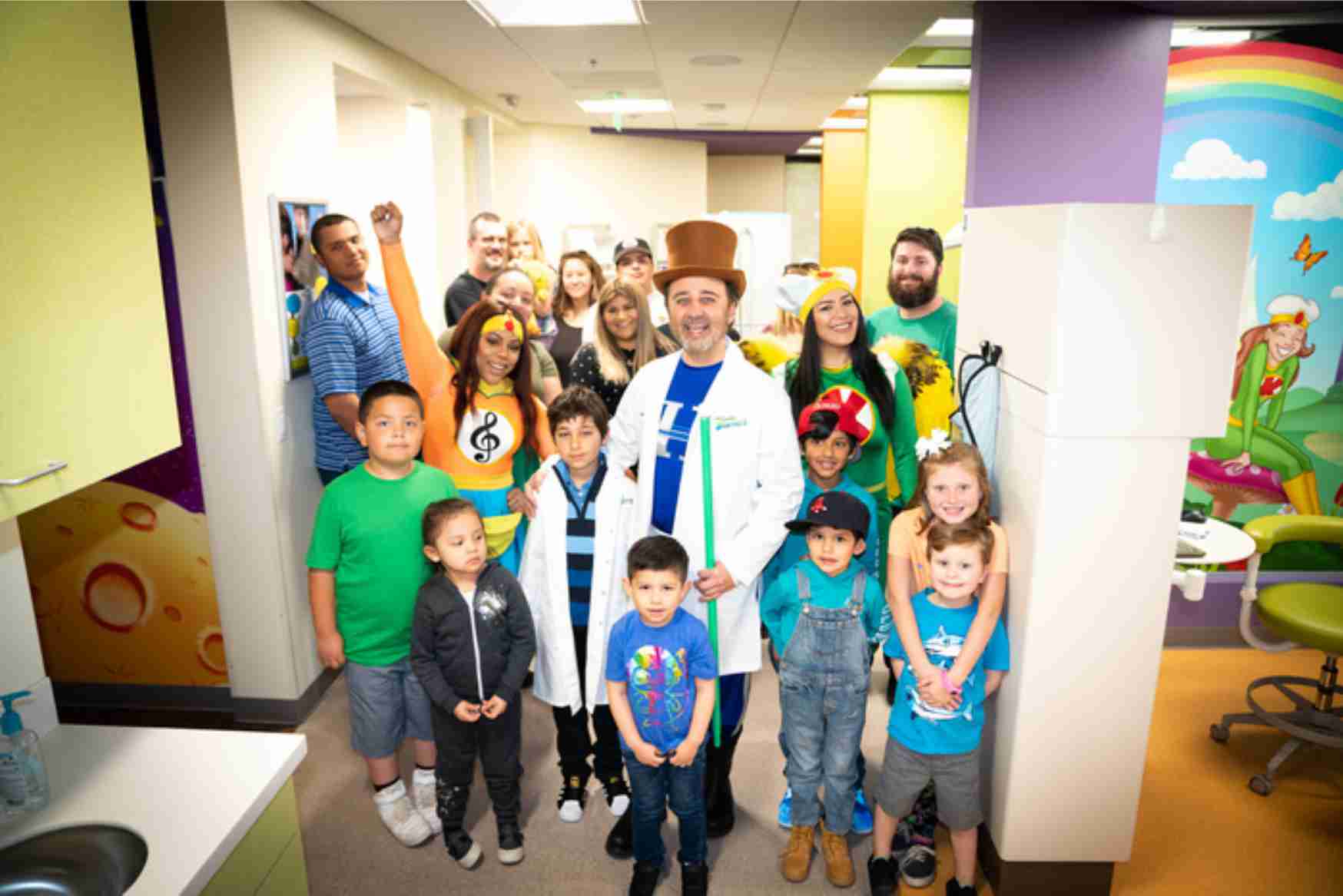 Dr. Kami Hoss standing with staff pediatric dental patients at The Super Dentists
