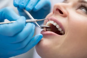 A dentist examining a patient’s teeth

