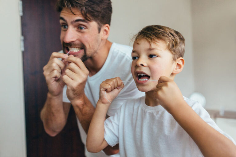Father and son flossing