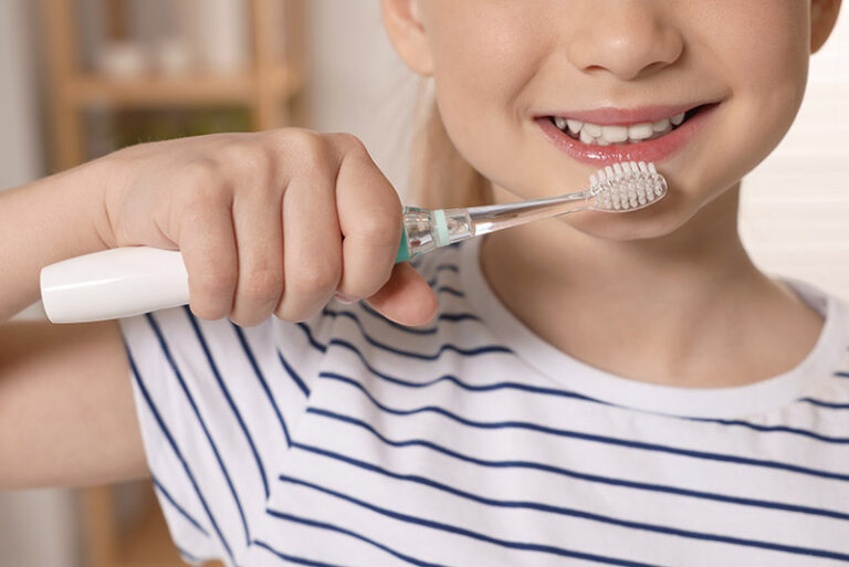 Young girl brushing her teeth