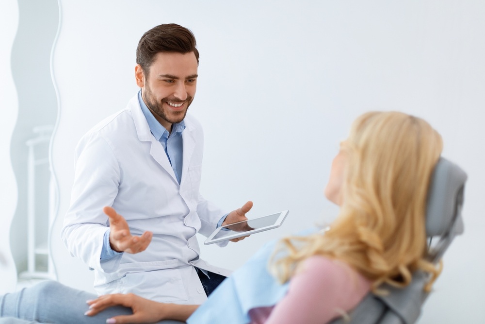 Dentist provides advice to patient experiencing stress-related bruxism