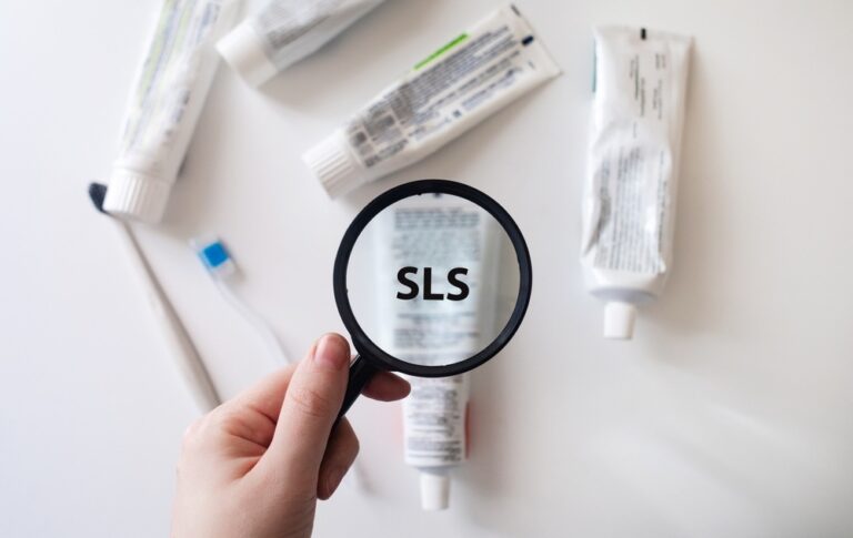 Toothpaste tube containing SLS as viewed through a magnifying glass