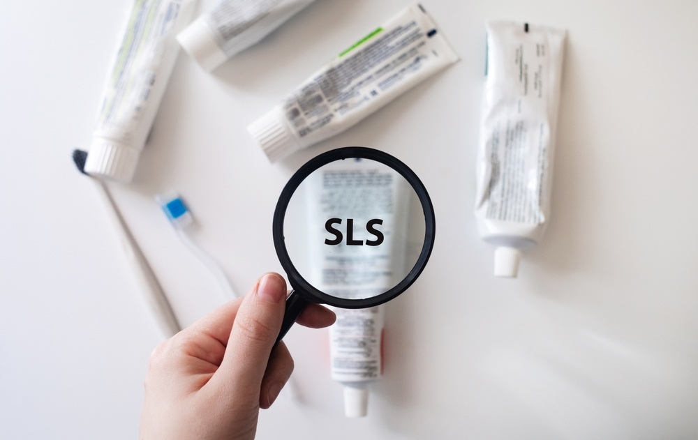 Toothpaste tube containing SLS as viewed through a magnifying glass