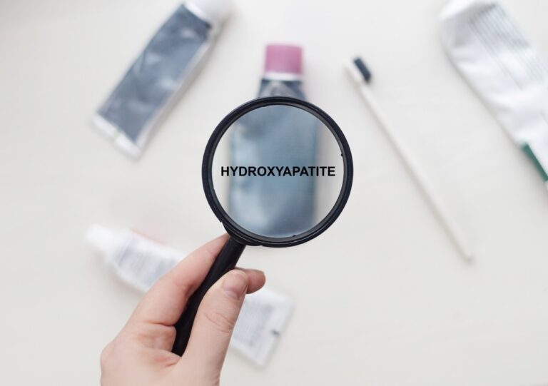 Hydroxyapatite written on a toothpaste tube shown under a magnifying glass